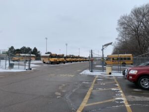 a row of school buses are parked in a parking lot
